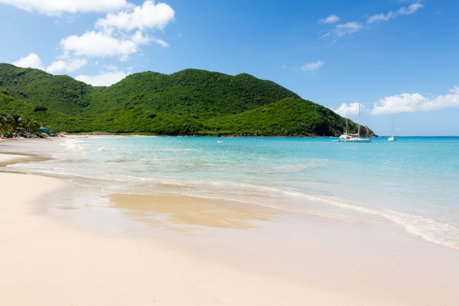 Crystal clear waters of the pristine beach of Anse Marcel on the island of St Martin in the Caribbean, one of our best luxury holiday destinations.