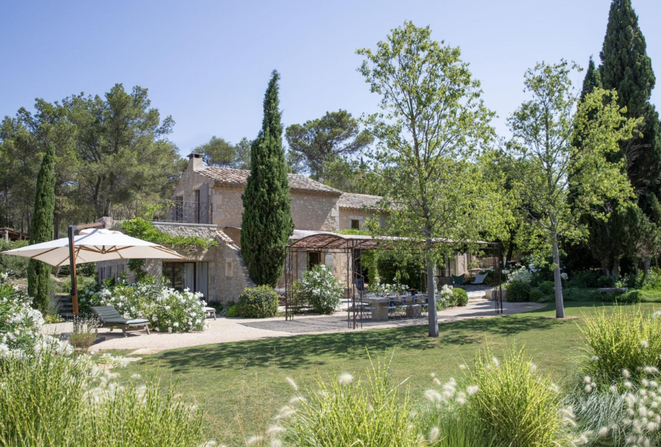 View across the stunning landscaped gardens to the main house of Villa Mas de Cinq Sous, one of the top luxury self catered villa rentals in Provence.