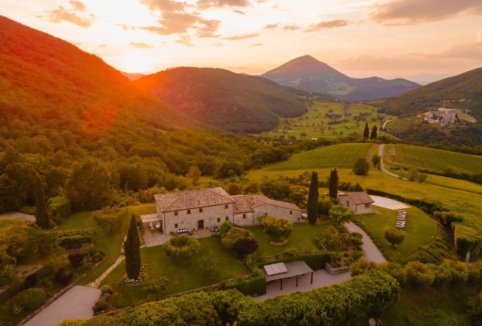 View over the green surroundings of The Murlo Estate in Umbria, with Villa Subtilia in the foreground, a lovely private luxury villa in Umbria.