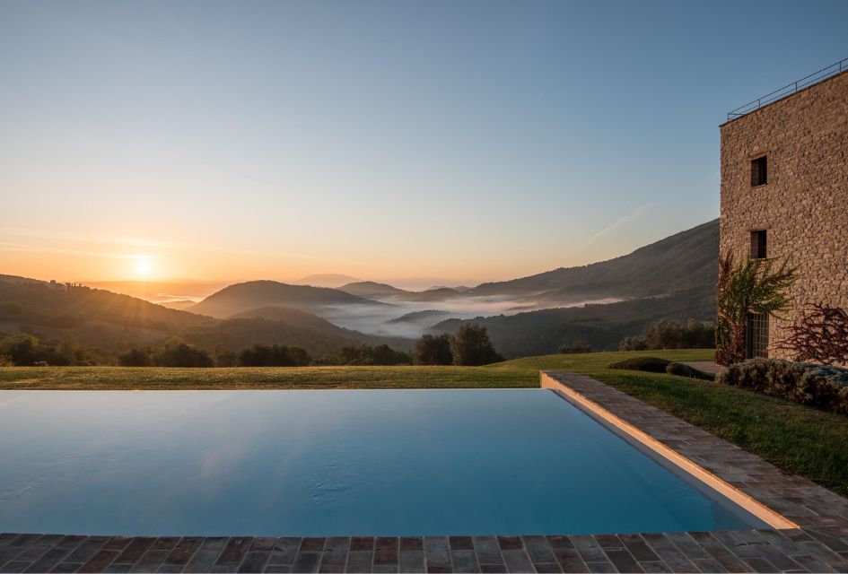 Sunset view of the rolling hills of the Murlo Estate, from the outdoor swimming pool of Villa Torre in Umbria.