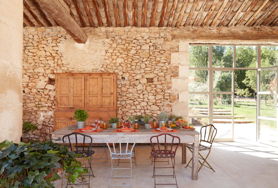 View of the alfresco dining area of Le Mas Vermentino, with the gardens in the background. This is a lovely private luxury villa in Provence.