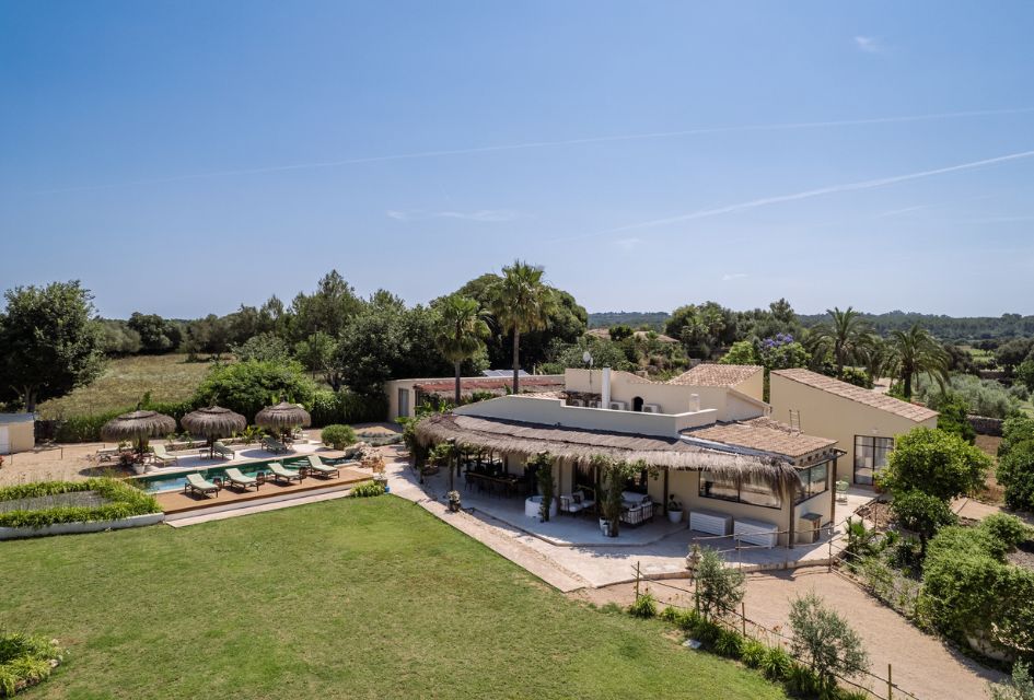 View over the luxury private villa of Casa Verano in Mallorca, surrounded by a green countryside.  