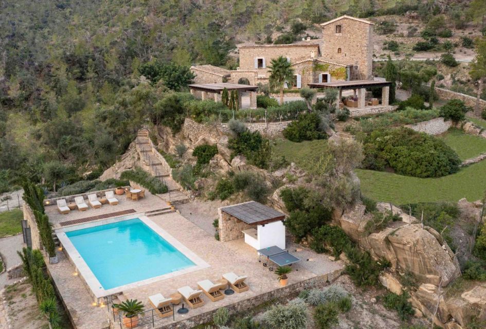 Drone shot of the Son Balagueret Villa, including pool, table tennis, large garden, and main house in the hillside of Mallorca.