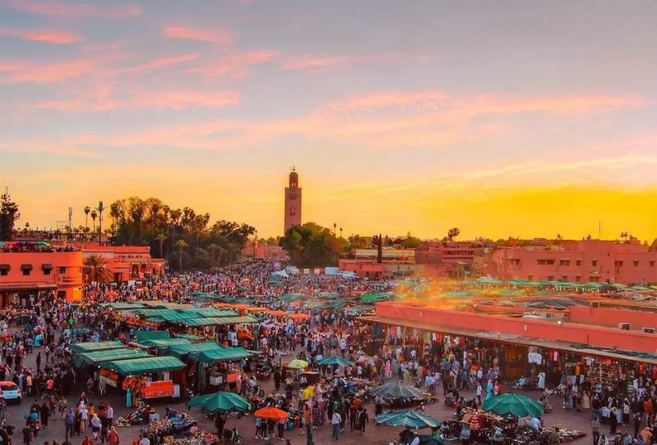 Sunset time over Jemaa El Fna, one of the main squares of Marrakech, filled with local markets.