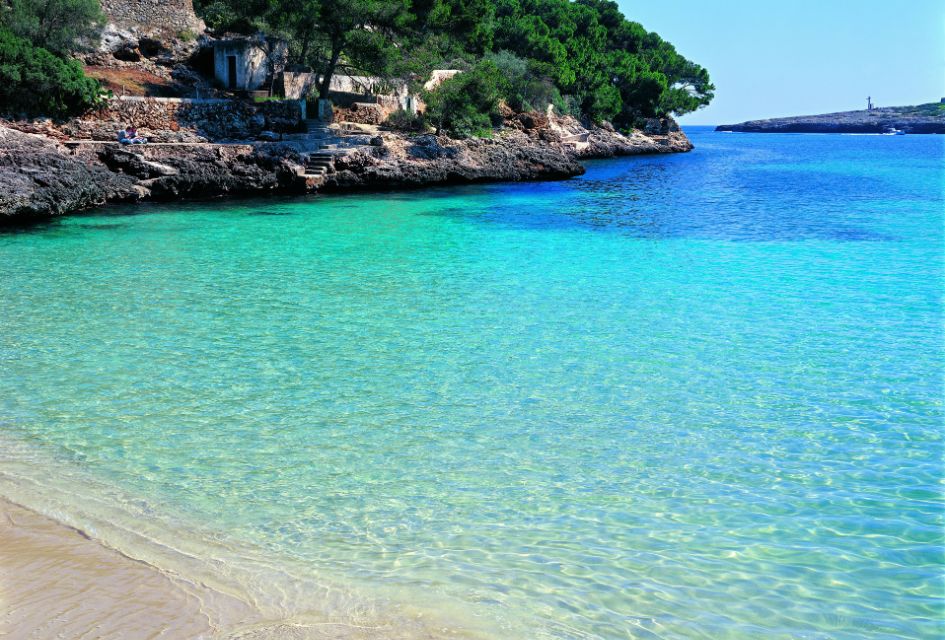 Foreground view of the crystal clear azure waters of Cala d'Or in Mallorca. One of the top 10 beaches in Mallroca.