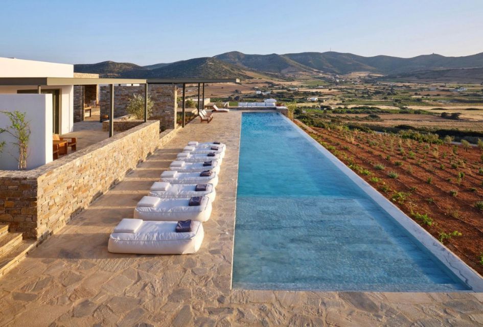 The impressive 30m swimming pool of Villa Cezanne, one of the top luxury villas in Antiparos, Greece. Surrounded by countryside and with a stone finish.