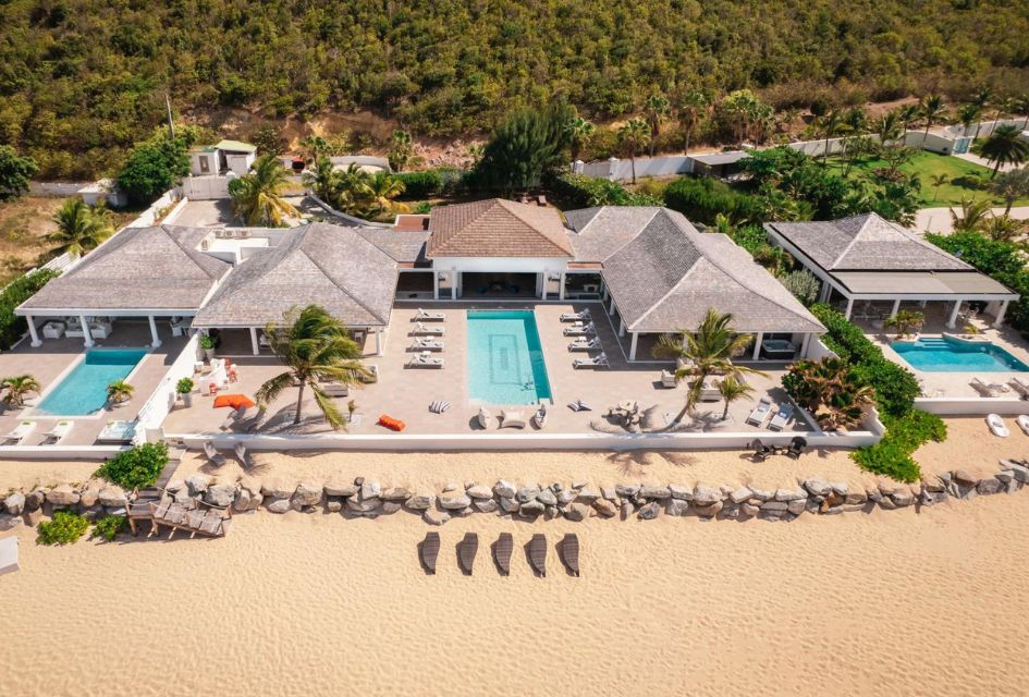 Beachside view of Villa La Perla Palais, a luxury villa with a pool in Saint Martin in the Caribbean. 3 swimming pools, steps from the beach, and a whole luxury villa to enjoy...