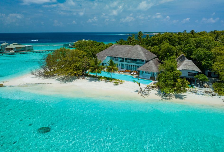 Aerial view of the beach front villa, Villa One in the Maldives, with crystal clear waters in the foreground