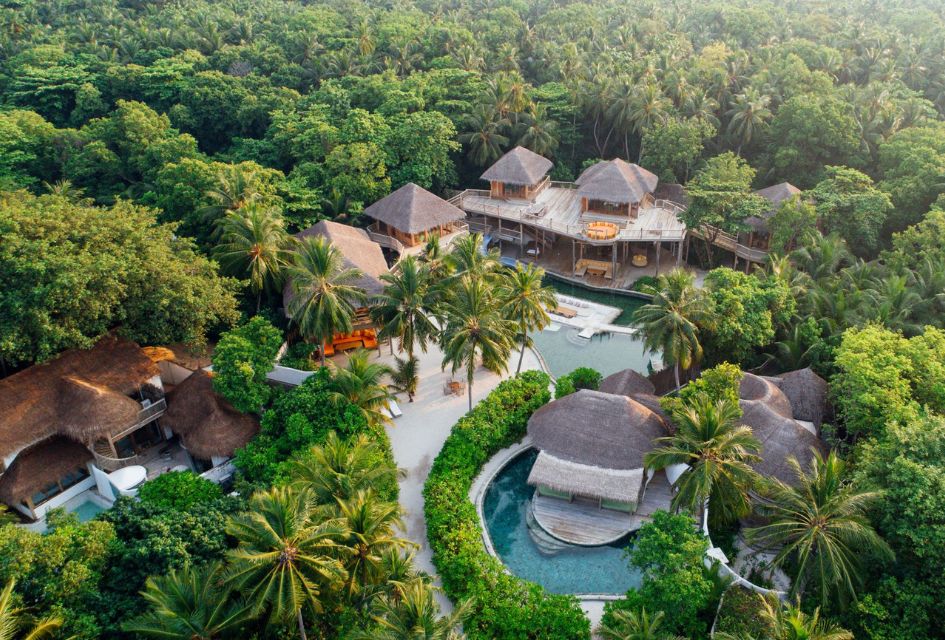 Aerial view of The Private Reserve, a large luxury villa in the Soneva Fushi Resort, surrounded by the verdant jungle.