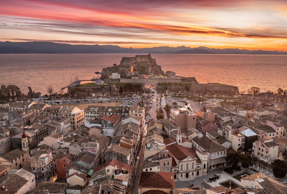 Sunset view over Corfu Town, with the Mediterranean waters in the background and its historical buildings in the foreground. This is the best island in Greece for unique lascapes!